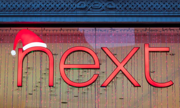 A Christmas themed logo of clothing retailer Next is seen at a store in London, on Dec. 2, 2021. (May James/Reuters)