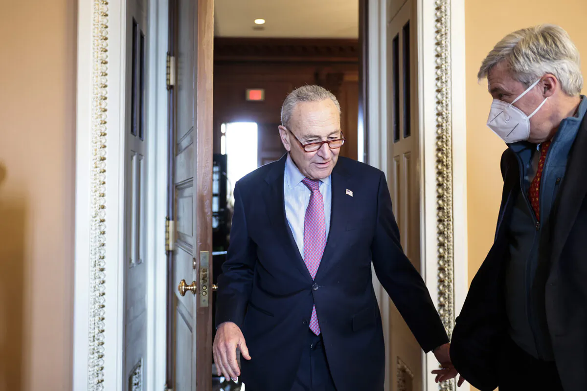 Senate Majority Leader Chuck Schumer, left, and Sen. Sheldon Whitehouse (D-R.I.) leave a caucus meeting with Senate Democrats at the Capitol Building in Washington on Dec. 17, 2021. (Getty Images)