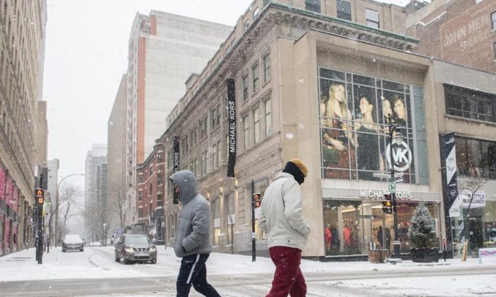 People walk along Ste-Catherine Street in Montreal, January 2, 2022.  (The Canadian Press/Graham Hughes)