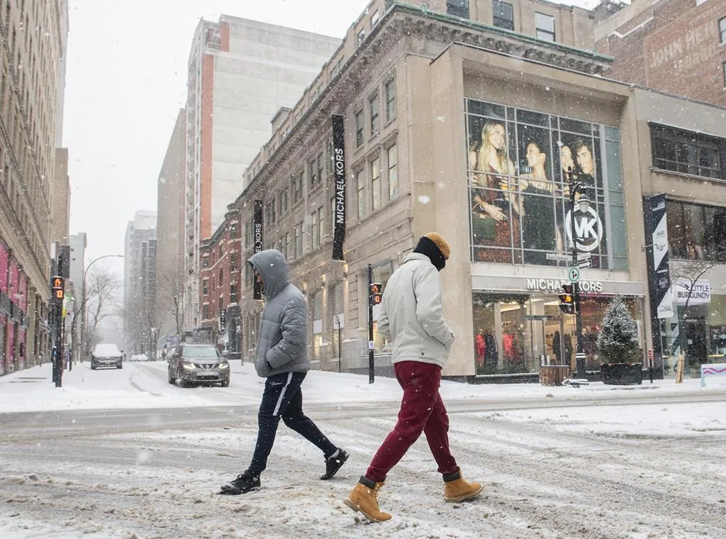 People walk along Ste-Catherine Street in Montreal, January 2, 2022.  (The Canadian Press/Graham Hughes)