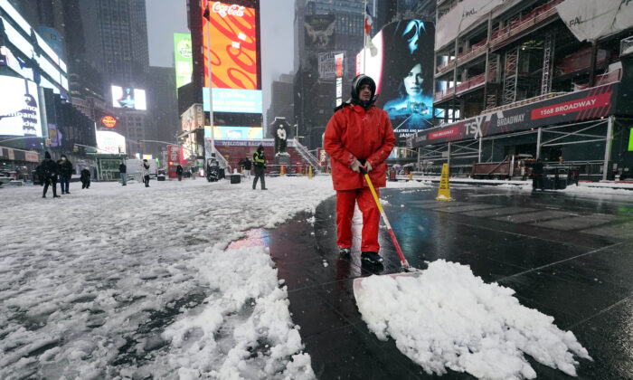 A worker clears snow in New York's Times Square, on Jan. 7, 2022. (Richard Drew/AP Photo)