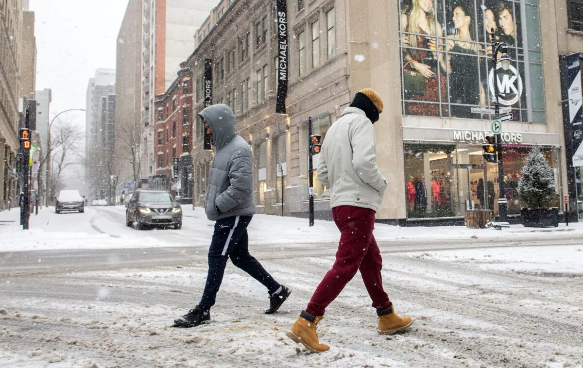 People walk along Sainte-Catherine Street in Montreal on Jan. 2, 2022, as measures put in place by the Quebec government, including the closure of stores, go into effect. (The Canadian Press/Graham Hughes)