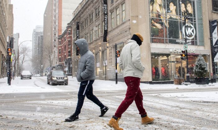 People walk along Sainte-Catherine Street in Montreal on Jan. 2, 2022, as measures put in place by the Quebec government, including the closure of stores, go into effect. (The Canadian Press/Graham Hughes)