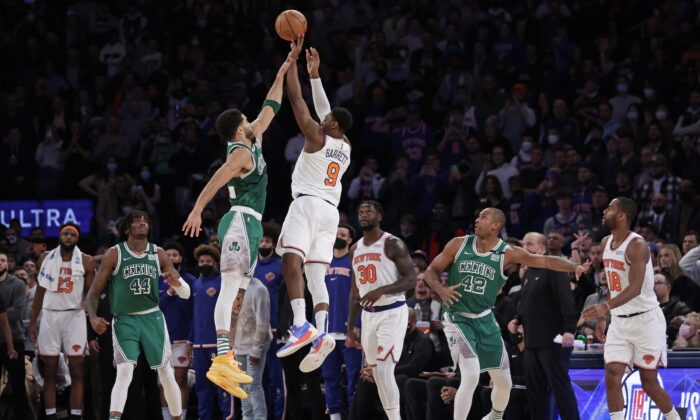 New York Knicks guard RJ Barrett (9) makes the game-winning 3-point basket in front of Boston Celtics forward Jayson Tatum during an NBA basketball game, in New York City, Jan. 6, 2022. (Adam Hunger/AP Photo)