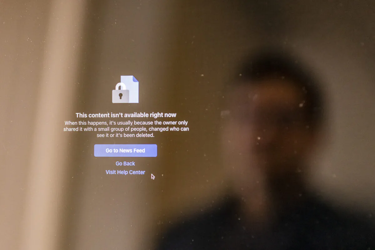 A man reflects off a computer screen displaying a disabled Facebook group in Irvine, Calif., on Jan. 7, 2021. (John Fredricks/The Epoch Times)