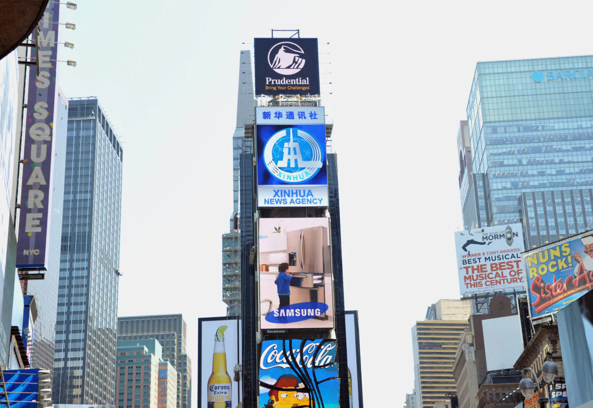 A new electronic billboard leased by Xinhua (2nd from top), the news agency operated by the Chinese government, makes its debut in New York's Times Square, on Aug. 1, 2011. The LED sign is 60 feet (18.3 meters) by 40 feet (12.2 meters) and is located on the building at 2 Times Square. (Stan Honda/AFP via Getty Images)