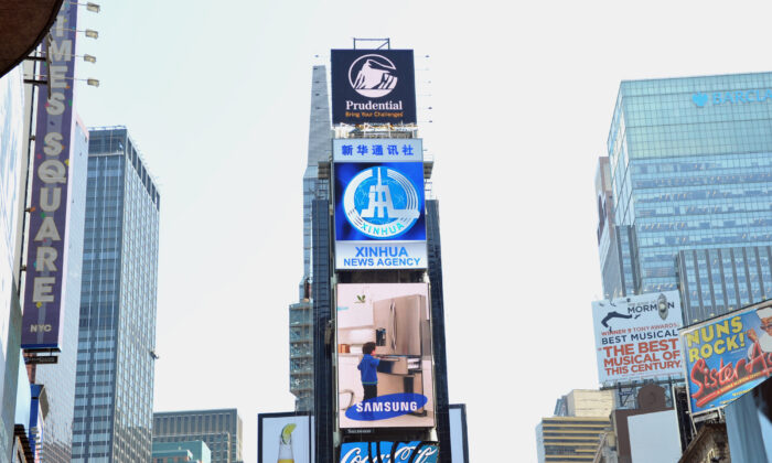 A new electronic billboard leased by Xinhua (2nd from top), the news agency operated by the Chinese government, makes its debut in New York's Times Square, on Aug. 1, 2011. The LED sign is 60 feet (18.3 meters) by 40 feet (12.2 meters) and is located on the building at 2 Times Square. (Stan Honda/AFP via Getty Images)
