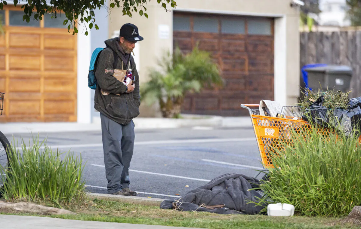 A homeless man stands near his encampment in Oceanside, Calif., on April 15, 2021. (John Fredricks/The Epoch Times)