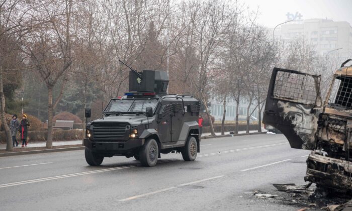 A military vehicle moves along a street, after violence that erupted following protests over hikes in fuel prices in central Almaty, Kazakhstan, on Jan. 7, 2022. (Alexandr Bogdanov/AFP via Getty Images)