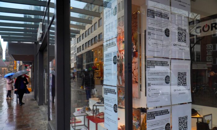 Notes for click and meet for customers with a QR code are seen in the windows of a shop in a shopping street in the centre of Bremen, northern Germany, on March 15, 2021. (Patrik Stollarz/AFP via Getty Images)