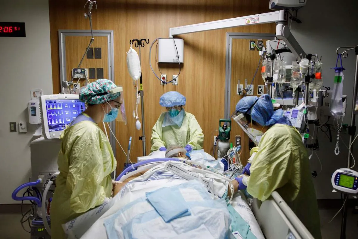 Respiratory therapist Flor Guevara repositions a patient suffering from COVID-19, with the help of other health-care workers, at Humber River Hospital's intensive care unit in Toronto on April 29, 2021. (Cole Burston/AFP via Getty Images)