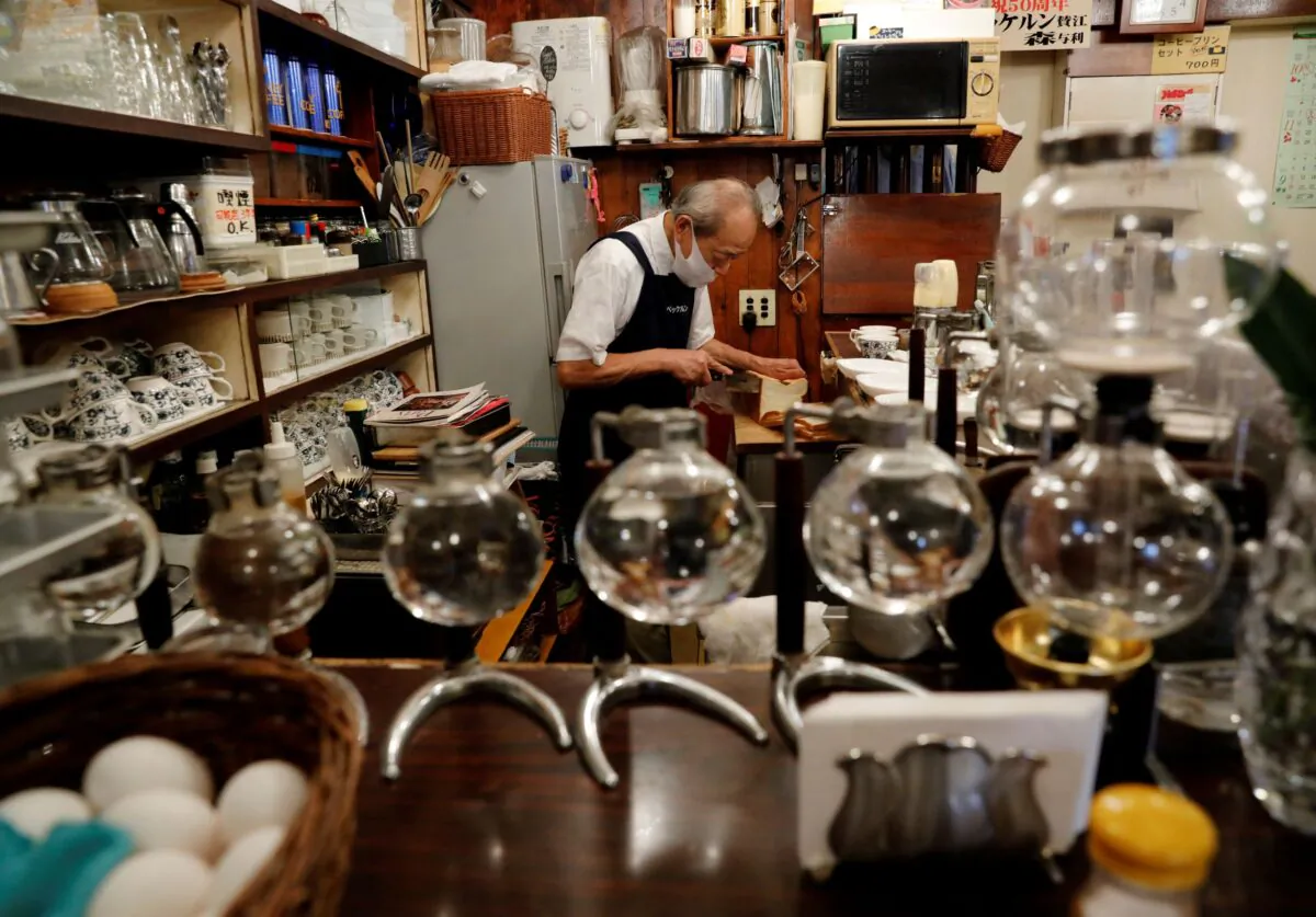 Shizuo Mori, the owner of Heckeln coffee shop makes sandwiches for customers at his shop in Tokyo, Japan, on Oct. 8, 2021. (Kim Kyung-Hoon/Reuters)