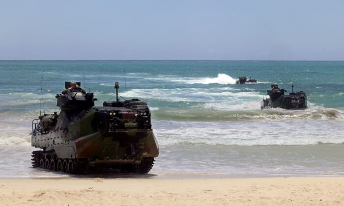 U.S. military Amphibious Assault Vehicles (AAV) from the USS Rushmore roll up on the beach during a Rim of the Pacific (RIMPAC) military exercise at Bellows Beach on Bellows Air Force Base, east of Honolulu on July 20, 2004. (Marco Garcia/Getty Images)