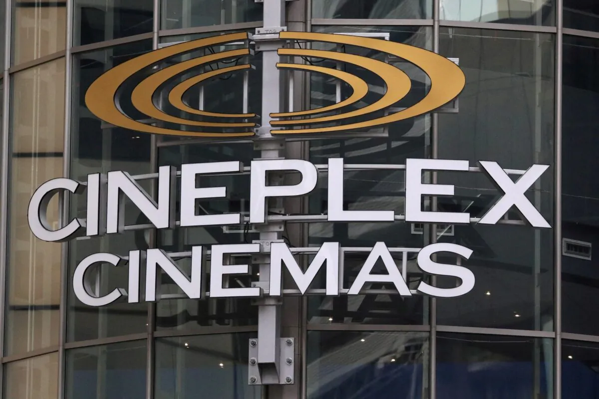 A Cineplex movie theatre sign looms over Yonge street in Toronto on March 16, 2020. (Reuters)