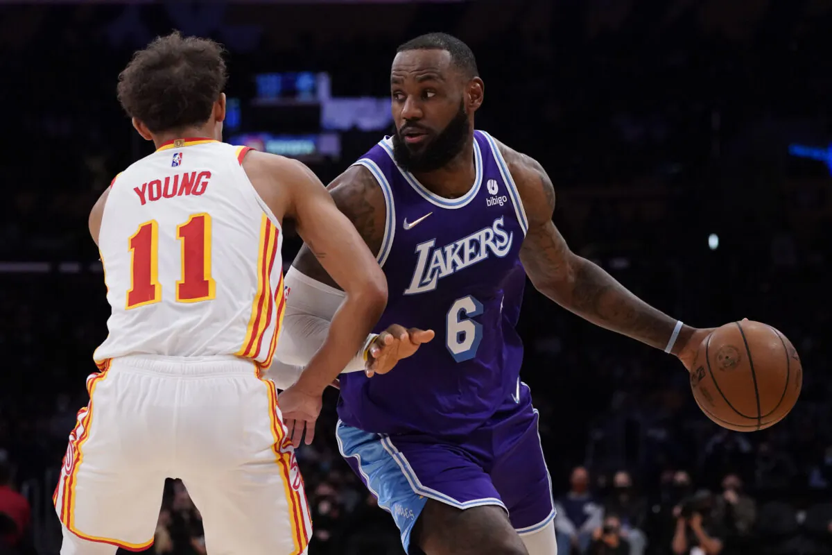 Atlanta Hawks guard Trae Young (11) defends against Los Angeles Lakers forward LeBron James (6) during the first half of an NBA basketball game in Los Angeles, Jan. 7, 2022. (Ashley Landis/AP Photo)