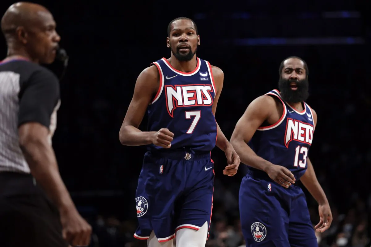 Brooklyn Nets forward Kevin Durant (7) and James Harden (13), during an NBA game against the Milwaukee Bucks in New York on Jan. 7, 2022. (Adam Hunger/AP Photo)