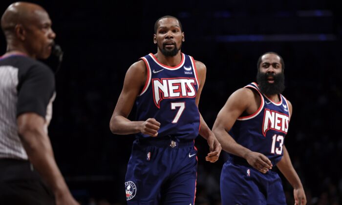 Brooklyn Nets forward Kevin Durant (7) and James Harden (13), during an NBA game against the Milwaukee Bucks in New York on Jan. 7, 2022. (Adam Hunger/AP Photo)