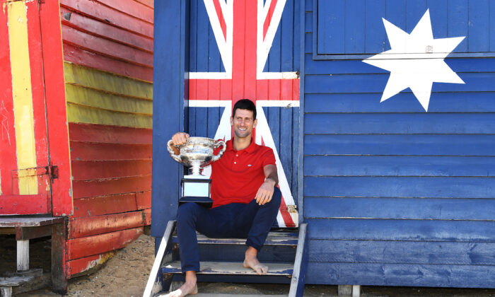 Novak Djokovic of Serbia poses for photographs on Brighton Beach with the Norman Brookes Challenge Cup following his Men's singles finals win against Daniil Medvedev of Russia at the Australian Open in Melbourne on Feb. 22, 2021. (AAP Image/Dave Hunt)