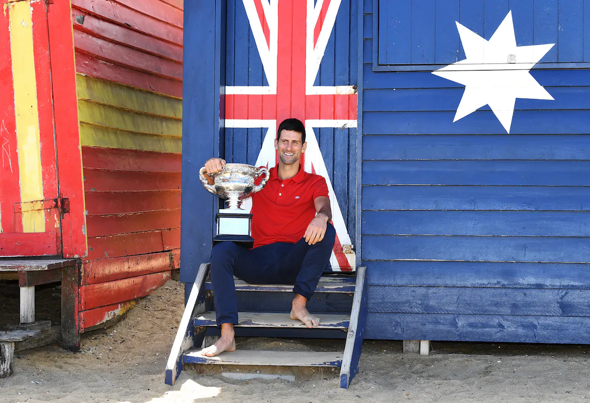 Novak Djokovic of Serbia poses for photographs on Brighton Beach with the Norman Brookes Challenge Cup following his Men's singles finals win against Daniil Medvedev of Russia at the Australian Open in Melbourne on Feb. 22, 2021. (AAP Image/Dave Hunt)