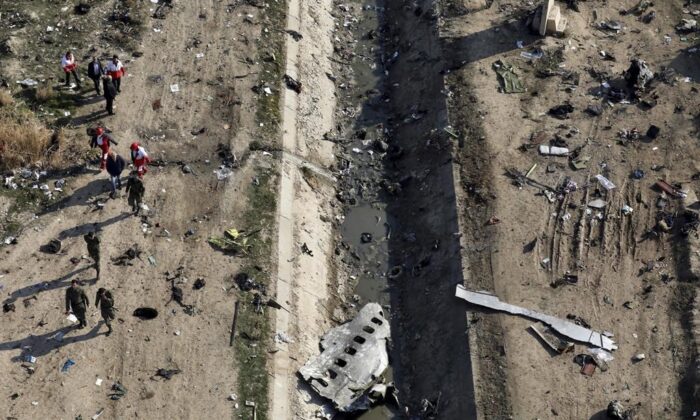 Rescue workers search the scene where a Ukrainian plane crashed in Shahedshahr, southwest of the capital Tehran, Iran, Jan. 8, 2020. (AP Photo/Ebrahim Noroozi) 