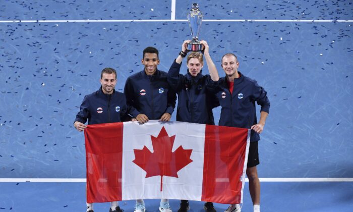 Team Canada's pose with their troops as they celebrate their win over Team Spain in the ATP Cup final in Sydney, Australia, on Jan. 9, 2022. (Dean Lewins/AAP Image via AP)