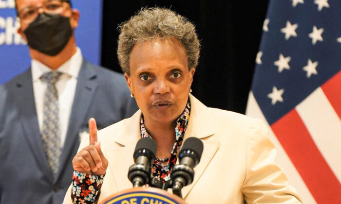 Chicago Mayor Lori Lightfoot, here speaking during a June 2021 press conference, is among big city mayors who support using federal pandemic assistance money to fund experimental guaranteed income programs, such as Chicago’s plan approved in April 2021 to provide 5,000 eligible recipients with $500 a month for one year beginning in August 2022. (Cara Ding/The Epoch Times)
