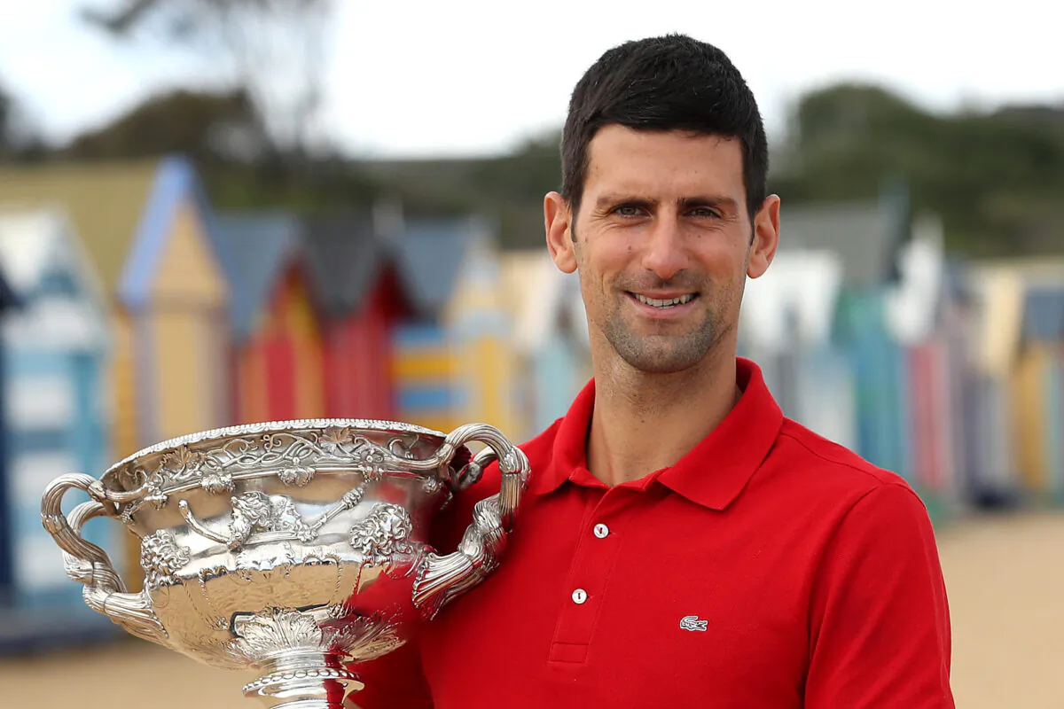 Novak Djokovic of Serbia poses with the Norman Brookes Challenge Cup after winning the 2021 Australian Open Men's Final, at Brighton Beach in Melbourne, Australia, on Feb. 22, 2021. (Graham Denholm/Getty Images)