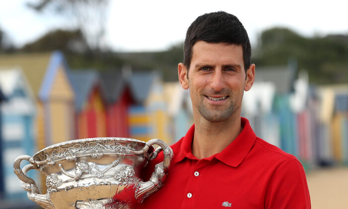 Novak Djokovic of Serbia poses with the Norman Brookes Challenge Cup after winning the 2021 Australian Open Men's Final, at Brighton Beach in Melbourne, Australia, on Feb. 22, 2021. (Graham Denholm/Getty Images)