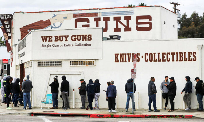 People stand in line outside the Martin B. Retting gun store in Culver City, Calif., on March 15, 2020. (Mario Tama/Getty Images)