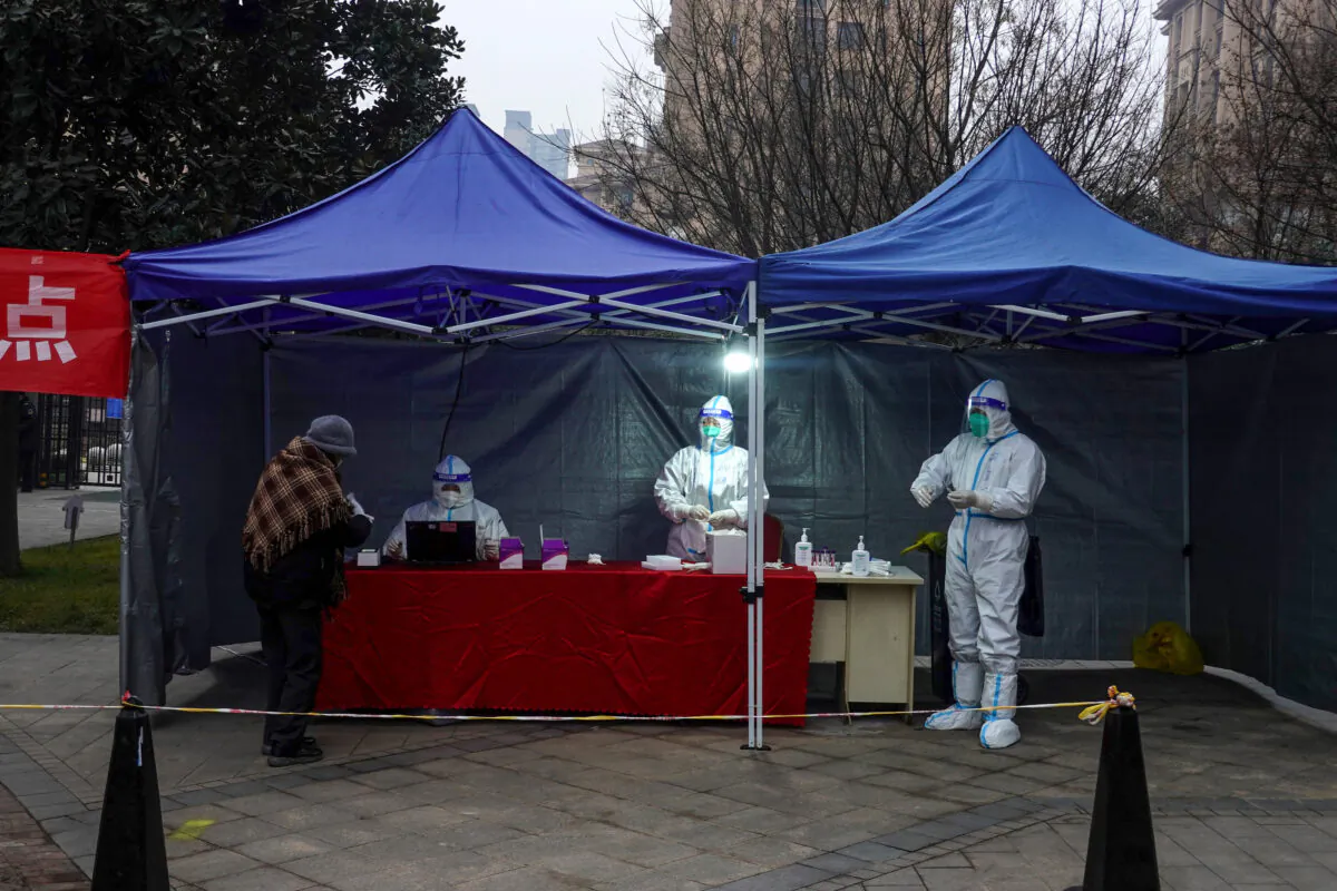 A resident prepares to undergo a nucleic acid test for COVID-19 in Xi'an, in northwestern China's Shaanxi Province on Jan. 4, 2022. (STR/AFP via Getty Images)