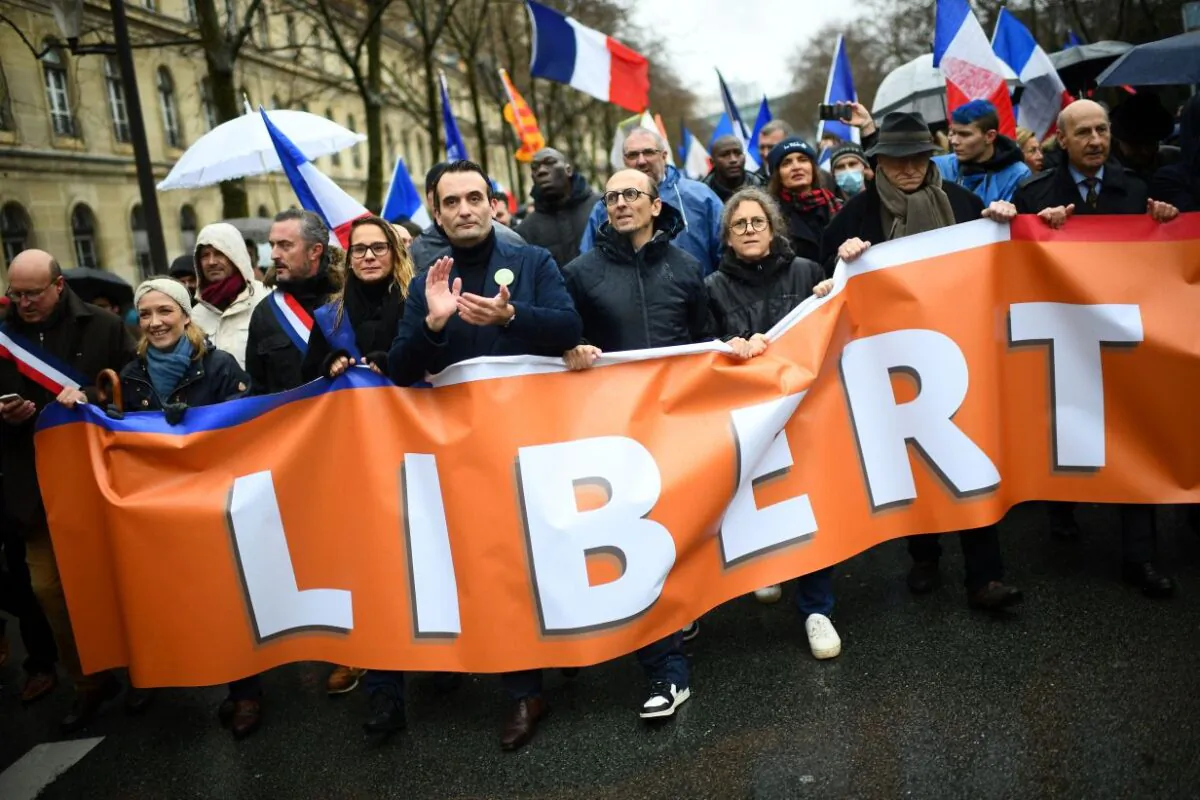 French party "Les Patriotes" leader Florian Philippot and lawyer Fabrice di Vizio march during a rally called by his party against the compulsory COVID-19 vaccination and the mandatory use of the health pass, in Paris, on Jan. 8, 2022. (Christophe Archambault/AFP via Getty Images)