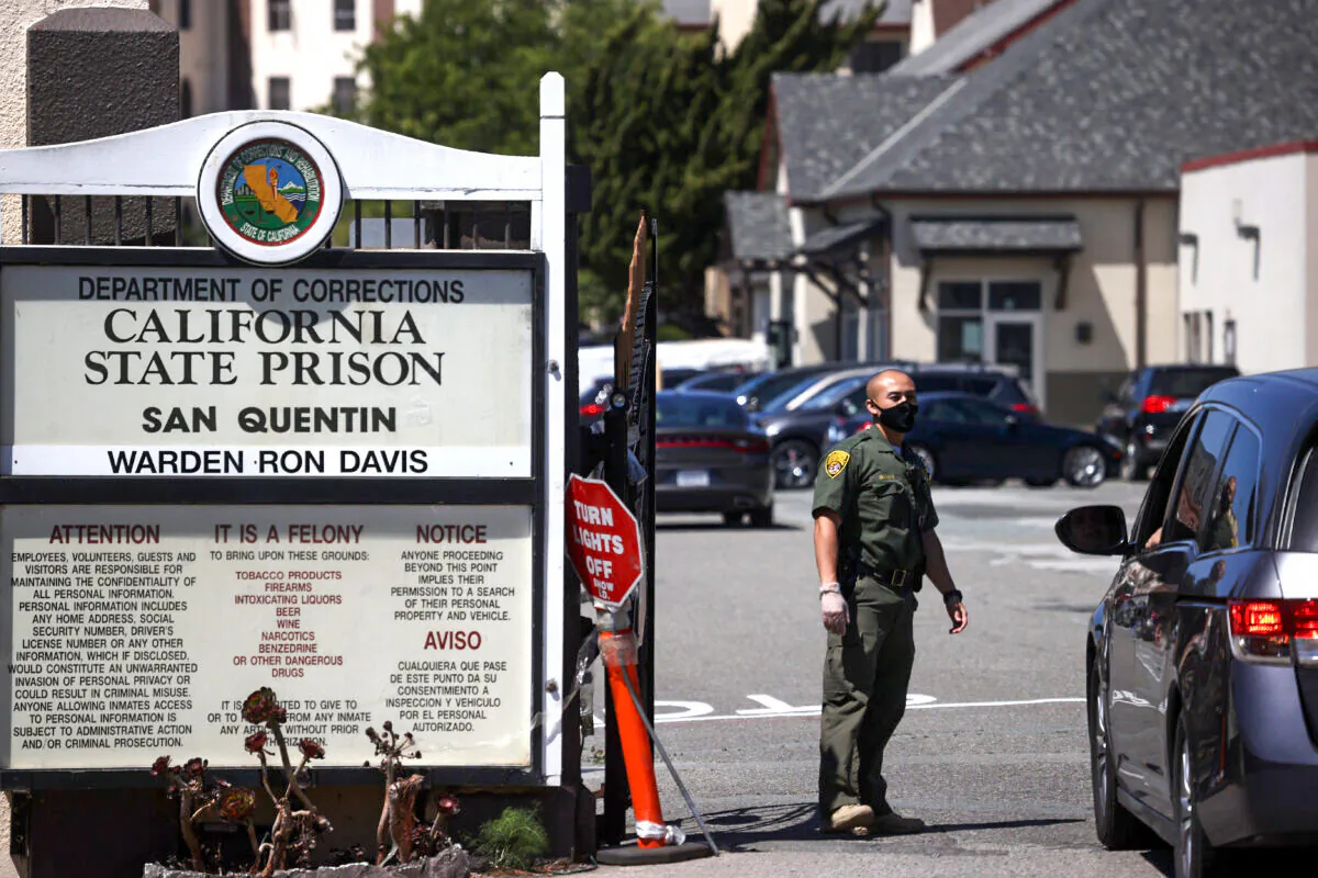A California Department of Corrections and Rehabilitation officer wears a protective mask as he stands guard at the front gate of San Quentin State Prison in San Quentin, Calif., on June 29, 2020. (Justin Sullivan/Getty Images)