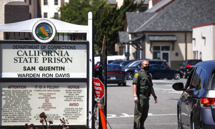 A California Department of Corrections and Rehabilitation officer stands guard at the front gate of San Quentin State Prison in San Quentin, Calif., on June 29, 2020. (Justin Sullivan/Getty Images)