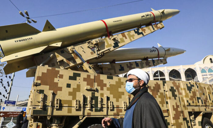 A cleric walks past Zolfaghar, top, and Dezful missiles in Tehran, Iran, on Jan. 7, 2022. (Vahid Salemi/AP Photo)