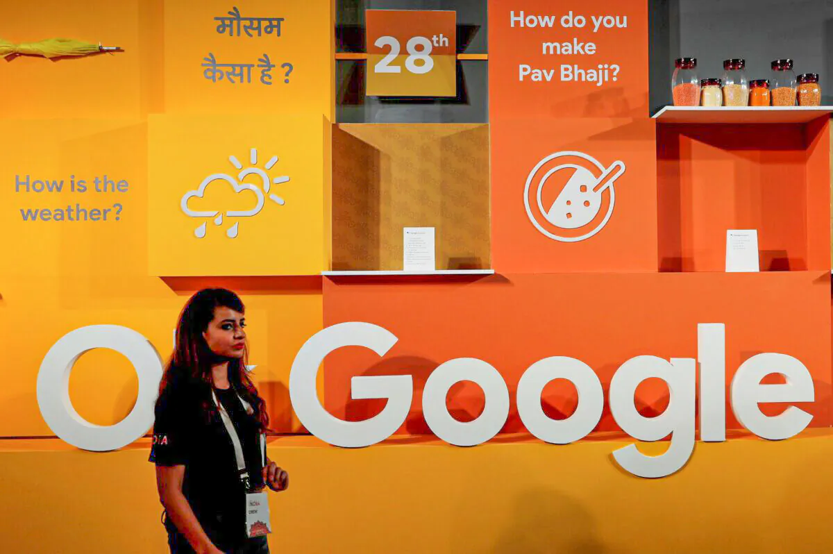 A woman walks past the logo of Google during an event in New Delhi, India, on Aug. 28, 2018. (Adnan Abidi/Reuters)