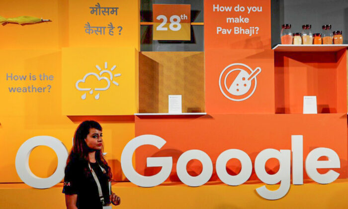 A woman walks past the logo of Google during an event in New Delhi, India, on Aug. 28, 2018. (Adnan Abidi/Reuters)