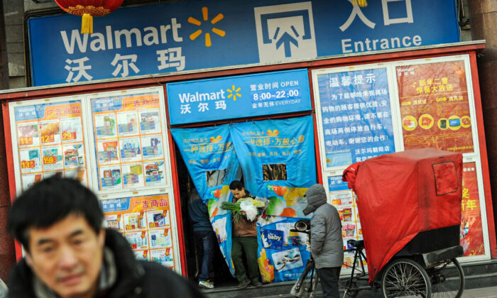 Chinese shoppers leave a Walmart store in Beijing on Jan. 3, 2012.  Chinese President Hu Jintao has warned that 