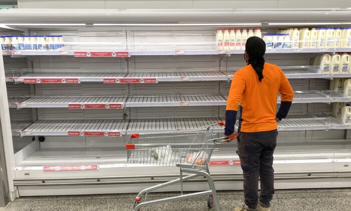 A shopper is seen looking at the empty shelves inside the Coles Supermarket at Kedron in Brisbane, Australia, on Jan. 8, 2021. (AAP Image/Darren England)