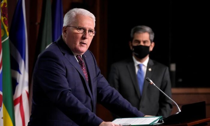 Conservative MP John Brassard responds to a question as MP Pierre Paul-Hus looks on during a news conference on the collection of mobile data by the Public Health Agency of Canada, in Ottawa on Jan. 10, 2022. (Adrian Wyld/The Canadian Press)