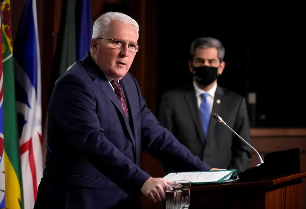 Conservative MP John Brassard responds to a question as MP Pierre Paul-Hus looks on during a news conference on the collection of mobile data by the Public Health Agency of Canada, in Ottawa on Jan. 10, 2022. (Adrian Wyld/The Canadian Press)