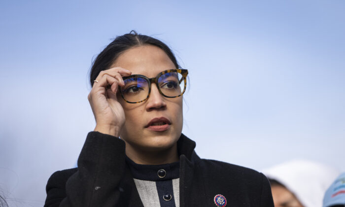 Rep. Alexandria Ocasio-Cortez (D-N.Y.) prepares to speak during a rally outside the U.S. Capitol in Washington on Dec. 7, 2021. (Drew Angerer/Getty Images)