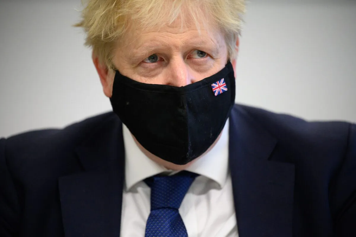 Britain's Prime Minister Boris Johnson speaks with pupils in a maths class as he makes a constituency visit to Oakwood School in Uxbridge, England, on Jan. 10, 2022. (Leon Neal/Getty Images)