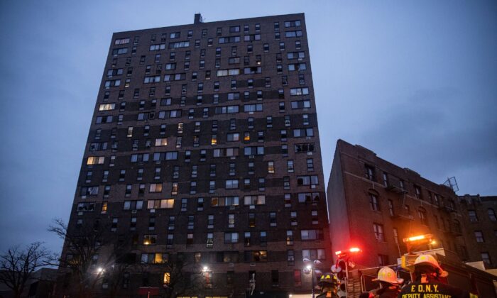 Emergency personnel work at the scene of a fatal fire at an apartment building in the Bronx, New York, on Jan. 9, 2022. (Jeenah Moon/AP Photo)