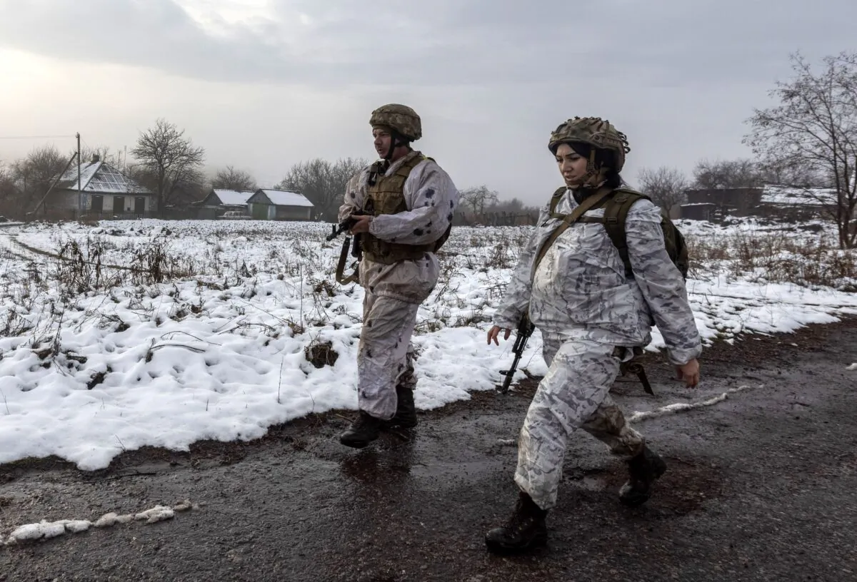 Ukrainian soldiers patrol the line of separation from pro-Russian rebels near Katerinivka, Donetsk region, Ukraine, on Dec 7, 2021. (Andriy Dubchak/AP Photo)