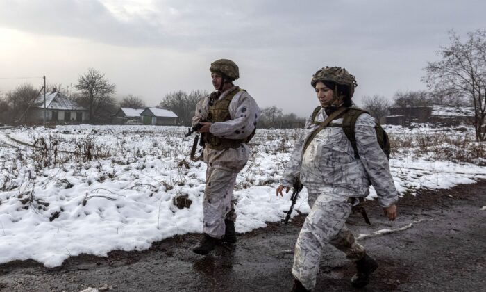 Ukrainian soldiers patrol the line of separation from pro-Russian rebels near Katerinivka, Donetsk region, Ukraine, on Dec 7, 2021. (Andriy Dubchak/AP Photo)