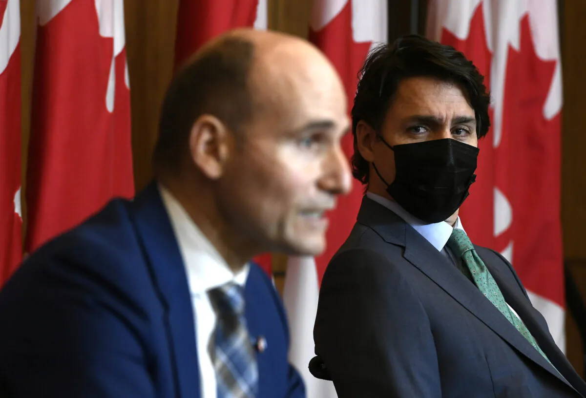 Prime Minister Justin Trudeau listens as Minister of Health Jean-Yves Duclos speaks during a news conference on the COVID-19 pandemic in Ottawa, on Jan. 5, 2022. (The Canadian Press/Justin Tang)
