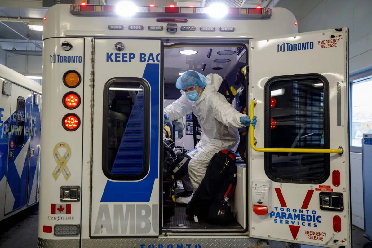 Paramedics and healthcare workers transfer a patient in Toronto on April 28, 2021. (Cole Burston/AFP Via Getty Images)