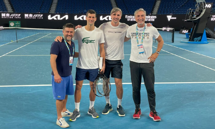 Serbian tennis player Novak Djokovic (2nd L) and his team on Rod Laver Arena Court at the Australian Open in Melbourne, Australia, in a photo uploaded to Twitter on Jan. 11, 2022. (Courtesy of DjokerNole/Twitter via Reuters)