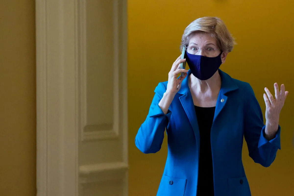 U.S. Senator Elizabeth Warren (D-MA) talks on the phone at the U.S. Capitol building on Dec. 14, 2021. (Elizabeth Frantz/Reuters)