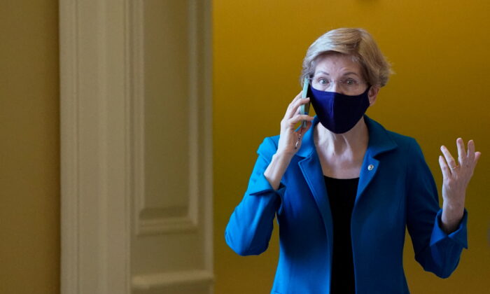 U.S. Senator Elizabeth Warren (D-MA) talks on the phone at the U.S. Capitol building on Dec. 14, 2021. (Elizabeth Frantz/Reuters)